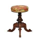A Victorian carved rosewood adjustable piano stool, the circular stuff over seat on a lappet