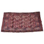 An antique Bokhara rug with three rows of four gols on a madder field