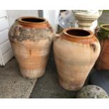 A slightly graduated pair of part-glazed terracotta garden olive jar planters