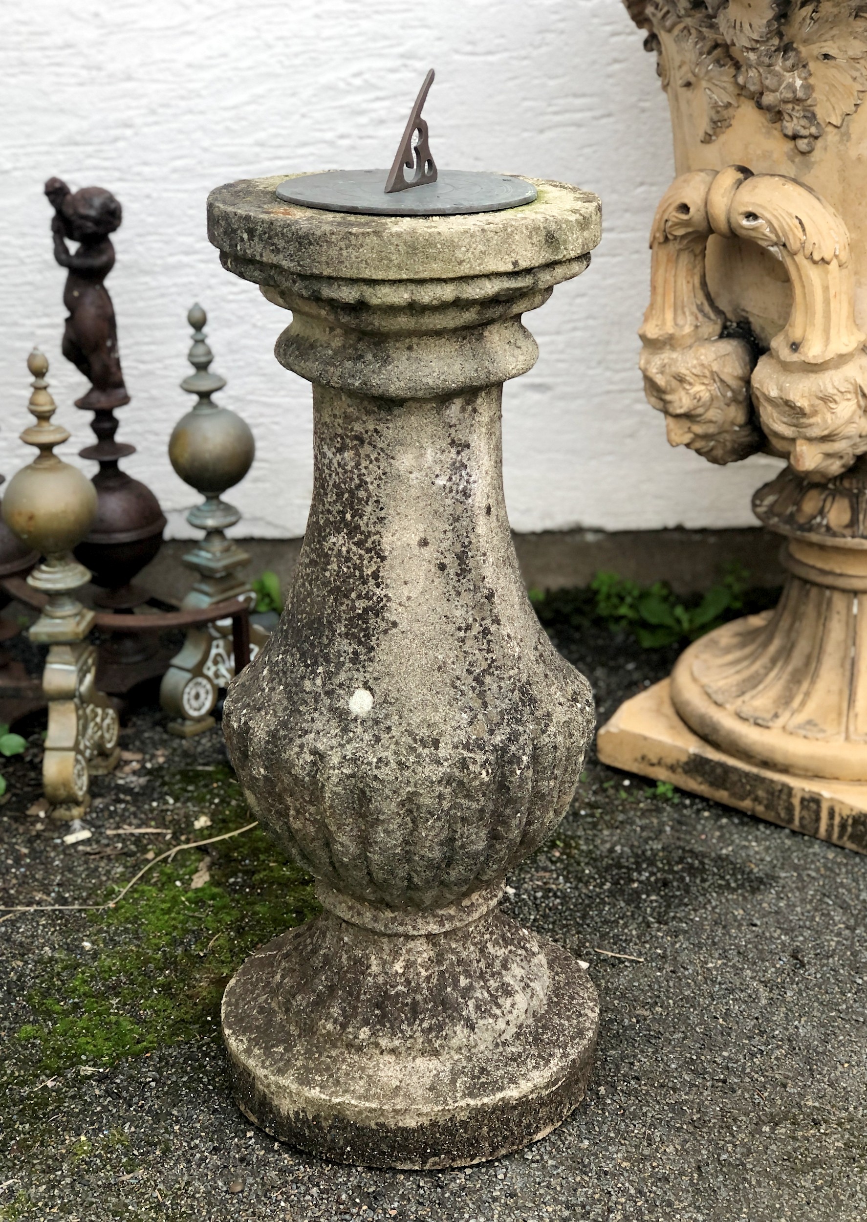 A composite stone and brass sundial of half gadrooned baluster form