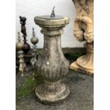A composite stone and brass sundial of half gadrooned baluster form