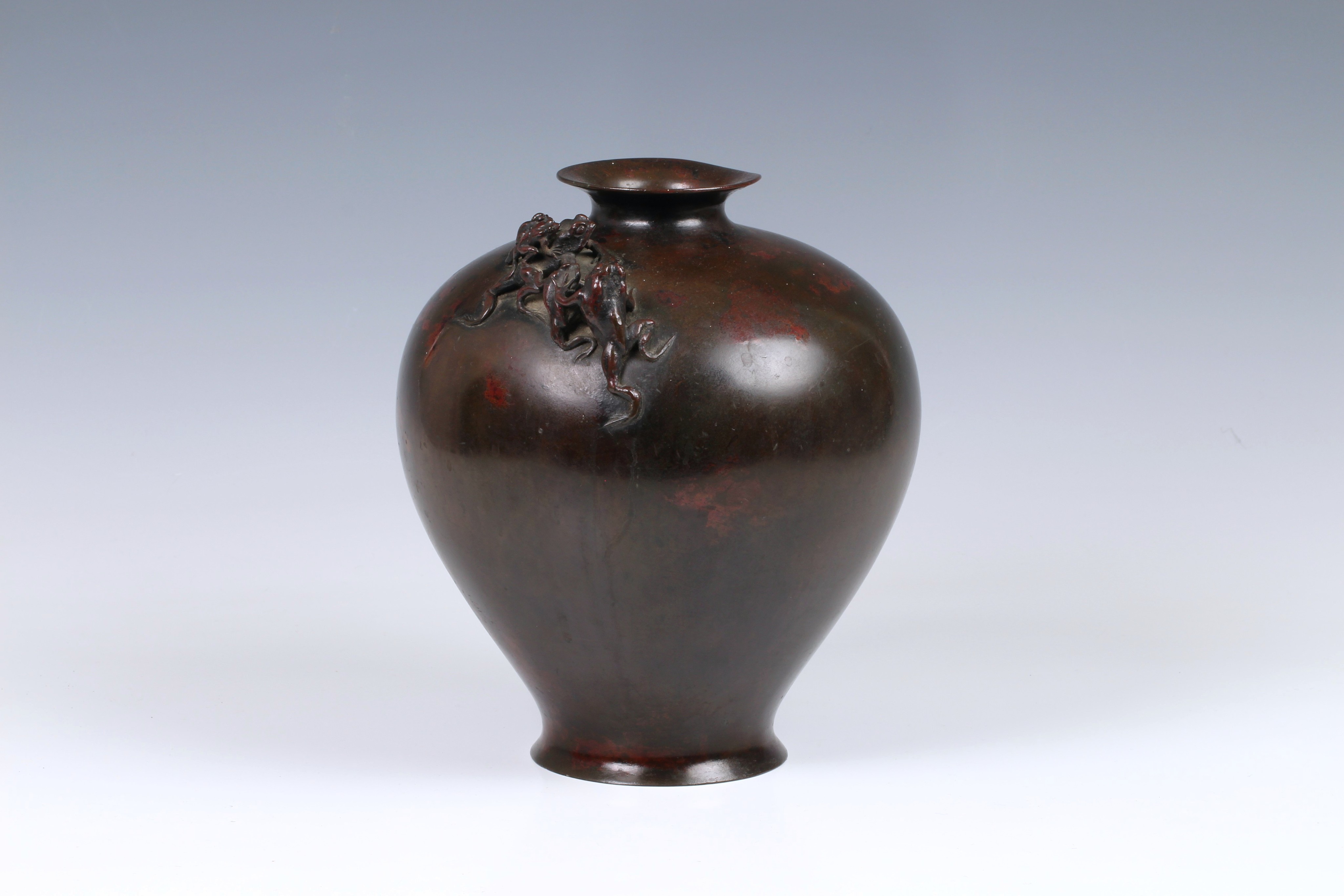 A Japanese patinated bronze vase, 19th century, of stout baluster form with everted rim and slightly