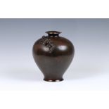 A Japanese patinated bronze vase, 19th century, of stout baluster form with everted rim and slightly