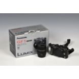 A Panasonic GF1 Lumix digital camera, with original box and lens.