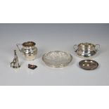 A small group of silver smalls, comprising a modern pip dish; an Edwardian two handle sugar bowl;