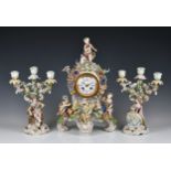 A Meissen style mantel clock garniture, the clock with applied putti and flowers, 19in. (48.2cm.)