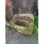 A well weathered stone trough, of shaped rectangular form, tapering from 26 - 19in. (66 - 48.