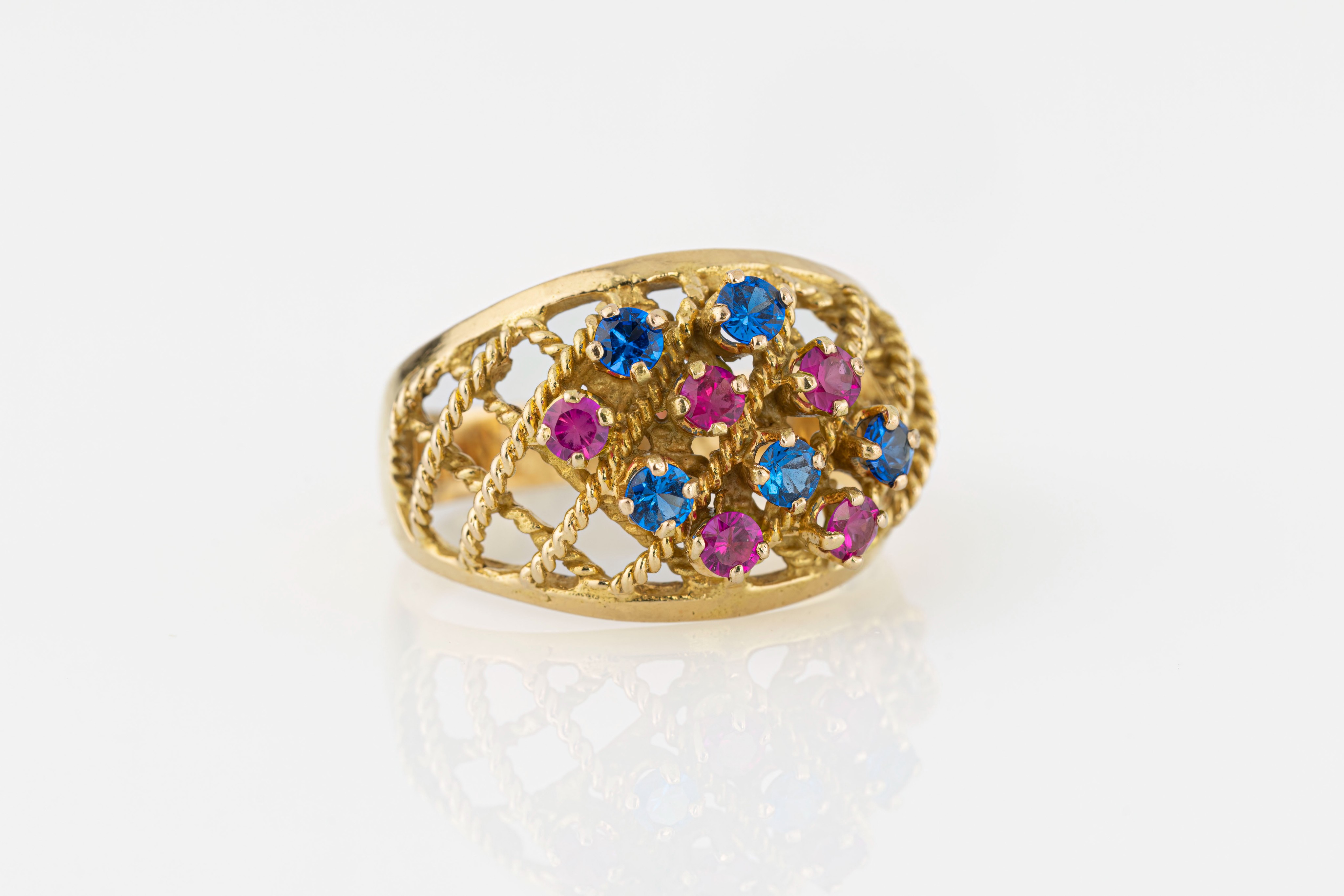 A vintage 18ct yellow gold dress ring, the rope-twist lattice ring set with round cut synthetic