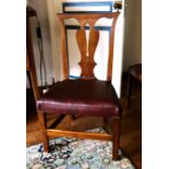 A set of four 18th century fruitwood chairs, with pierced vase back slats, on chamfered square front