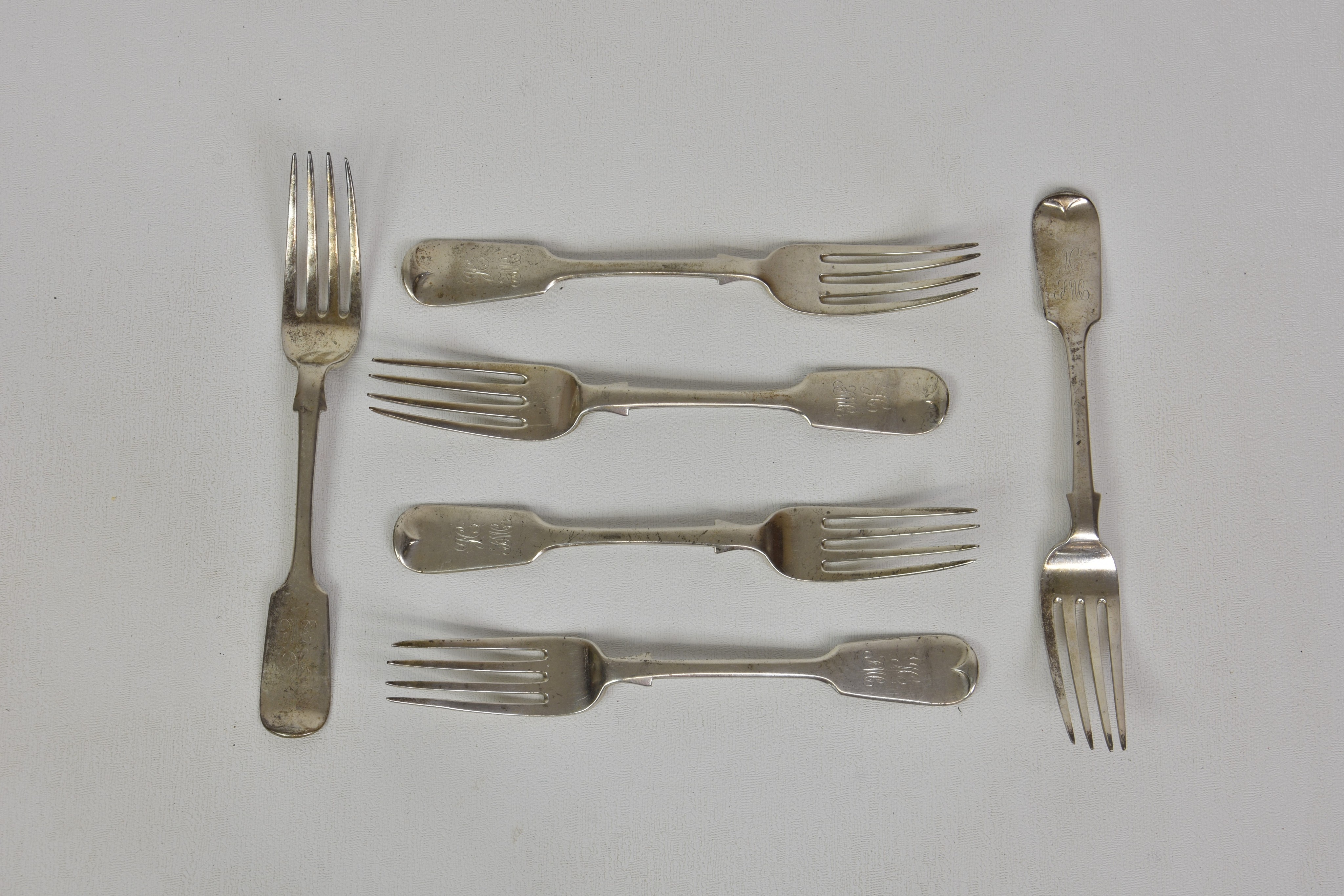 A set of six Channel Island Victorian silver fiddle pattern dessert forks, over stamped 'J.P.G' (