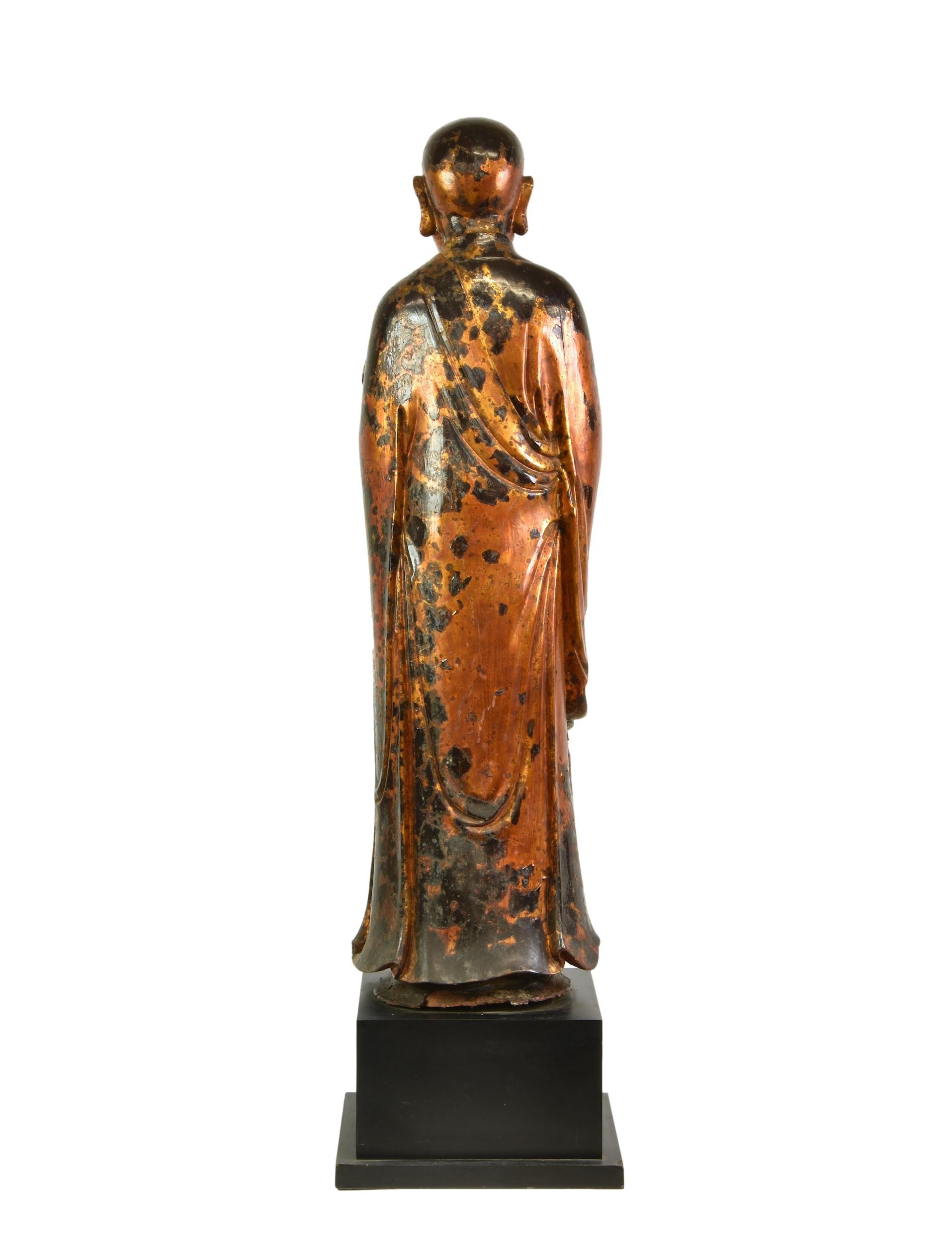 A lacquered and gilt carved wooden figure of a standing monk or Lohan, probably Burmese, Mandalay - Image 2 of 2