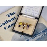A boxed 18ct Gold Brooch in the form of a pole with three enamel pennants, stamped 'Benzie Cowes',