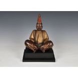 A Chinese patinated and painted bronze figure of Buddha Shakyamuni, 20th century, seated holding a