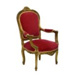 A French 18th century style carved giltwood open armchair, 20th century, the upholstered, slightly