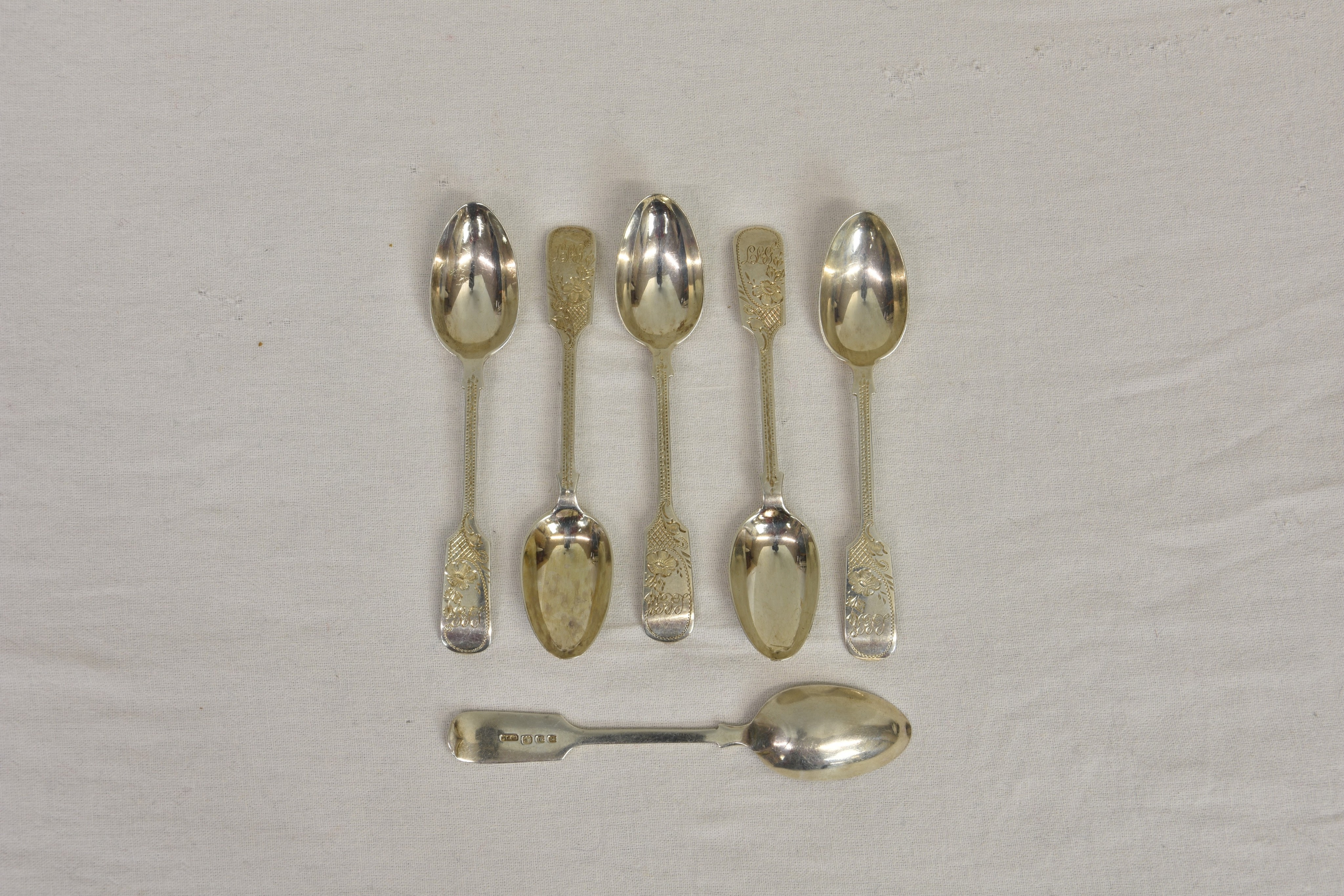 A set of six Channel Islands silver bright cut fiddle pattern teaspoons, CT Maine, London 1909,