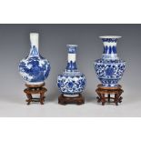 Three Chinese blue and white porcelain vases, 20th century, one of bottle form, painted with a