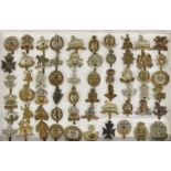A large collection of approximately seventy five (75) various Military cap badges, to include