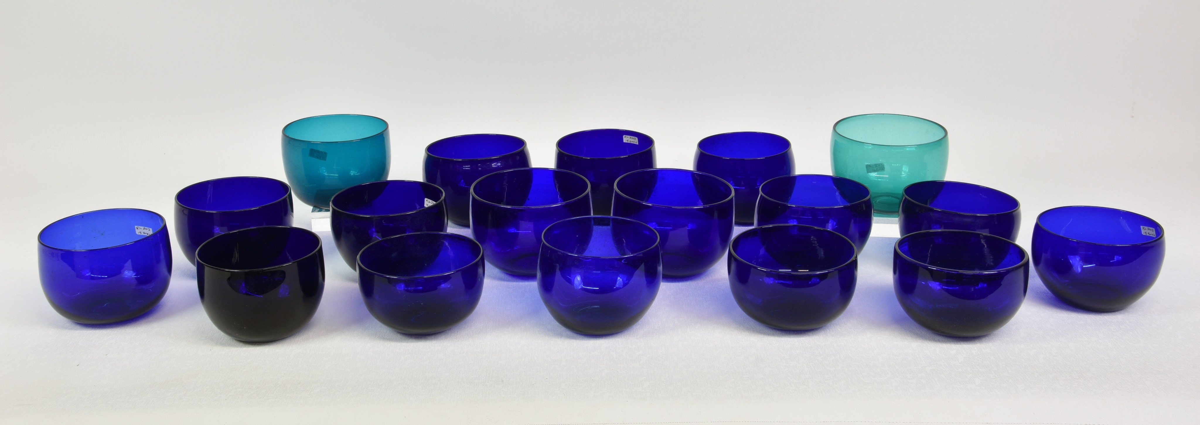A collection of sixteen Bristol blue glass finger bowls, plus two green glass finger bowls, ground