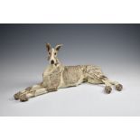 Elaine Peto (British, b.1963), a studio pottery stoneware model of a recumbent dog, impressed