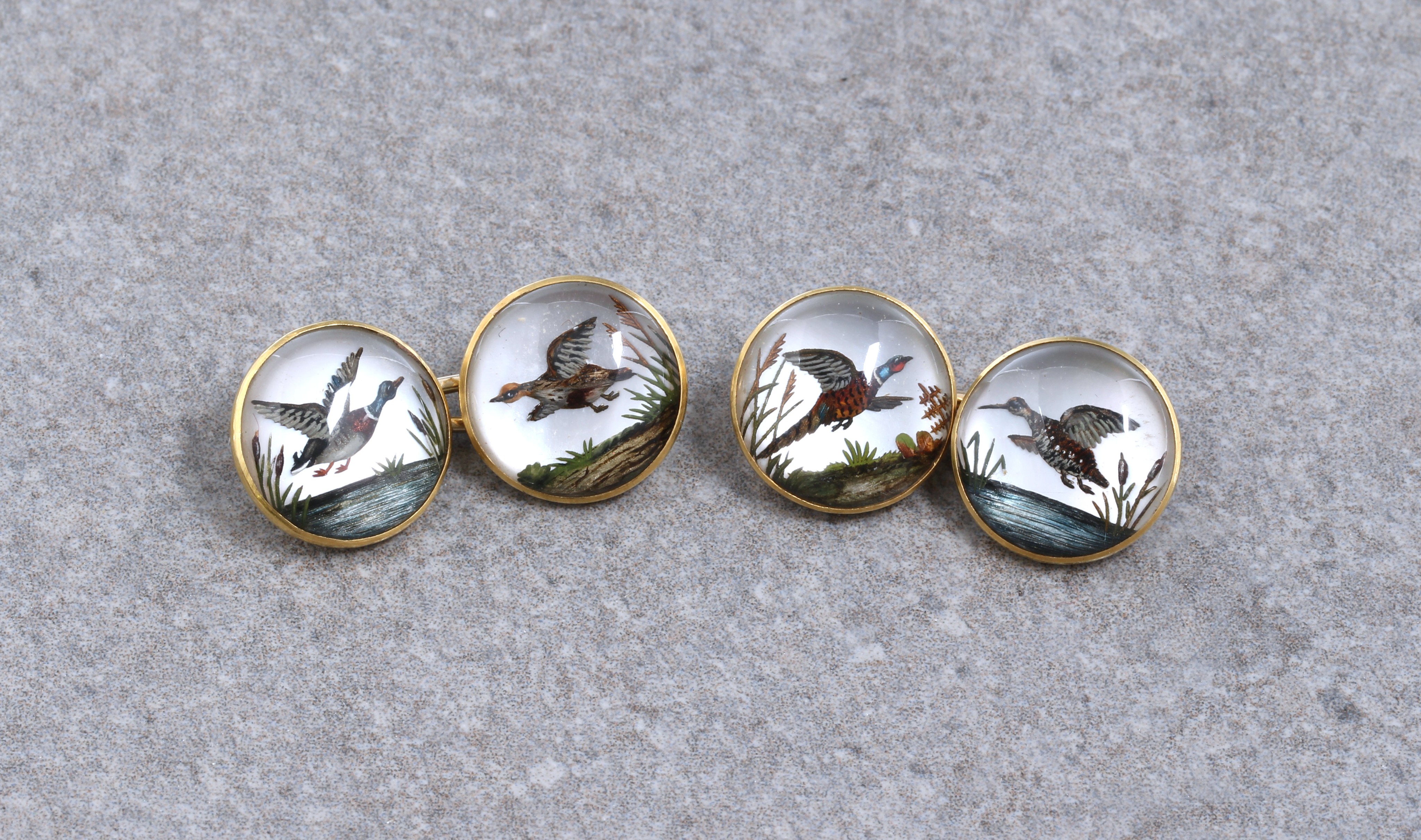 A pair 18ct gold framed Essex Crystal cufflinks, depicting game birds in flight, including wild