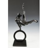A large contemporary patinated bronze Male Gymnast sculpture, the gymnast performing flare on a