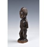 A Baule standing male figure, Ivory Coast, West Africa, probably mid-20th century, the carved wooden