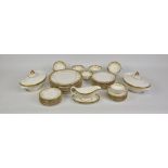 A Royal Doulton ‘Belmont’ pattern part dinner service, with gold encrusted band and gold scrolls and