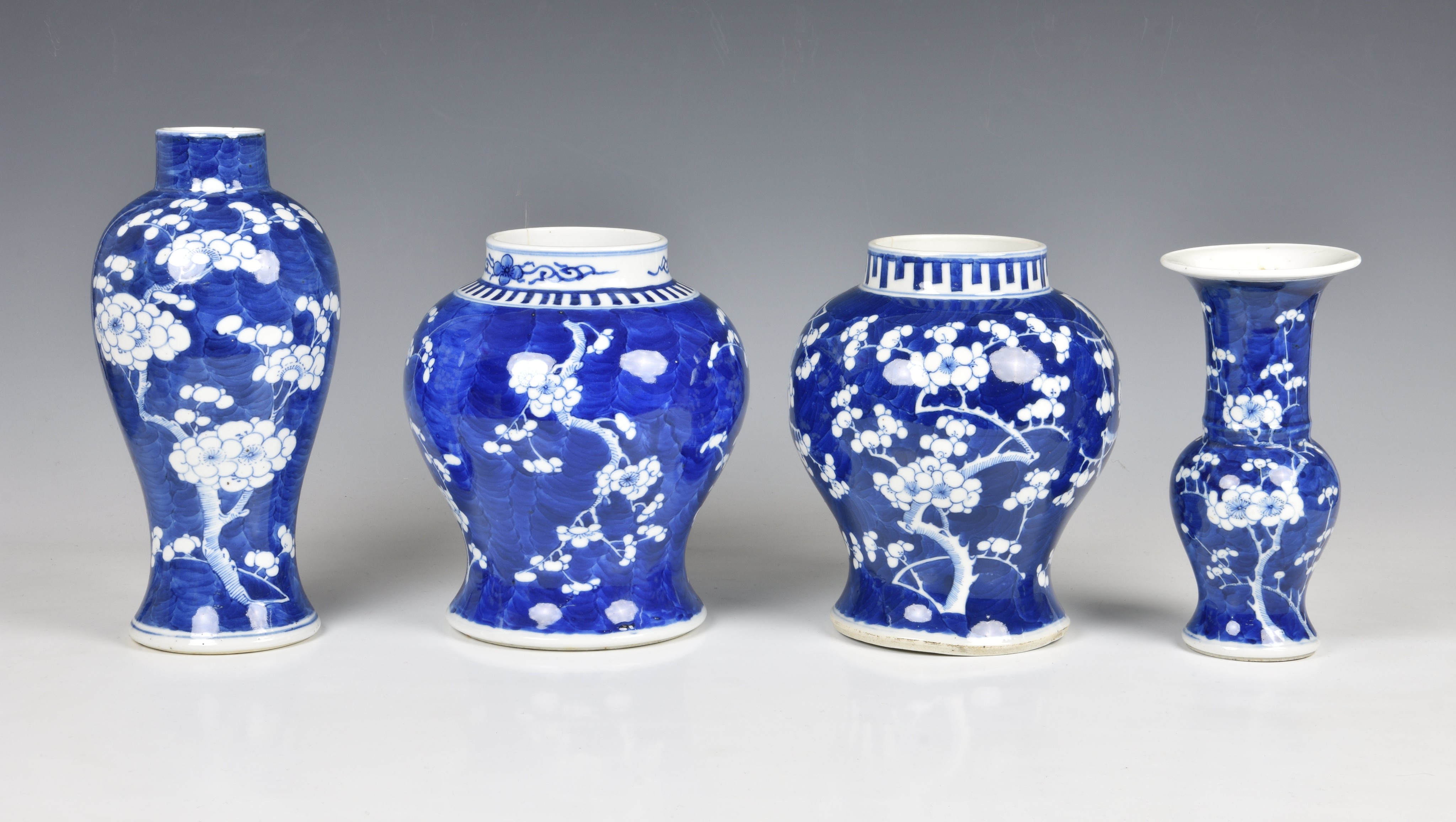 Four Chinese blue and white prunus blossom decorated vases, 20th century, comprising an inverted