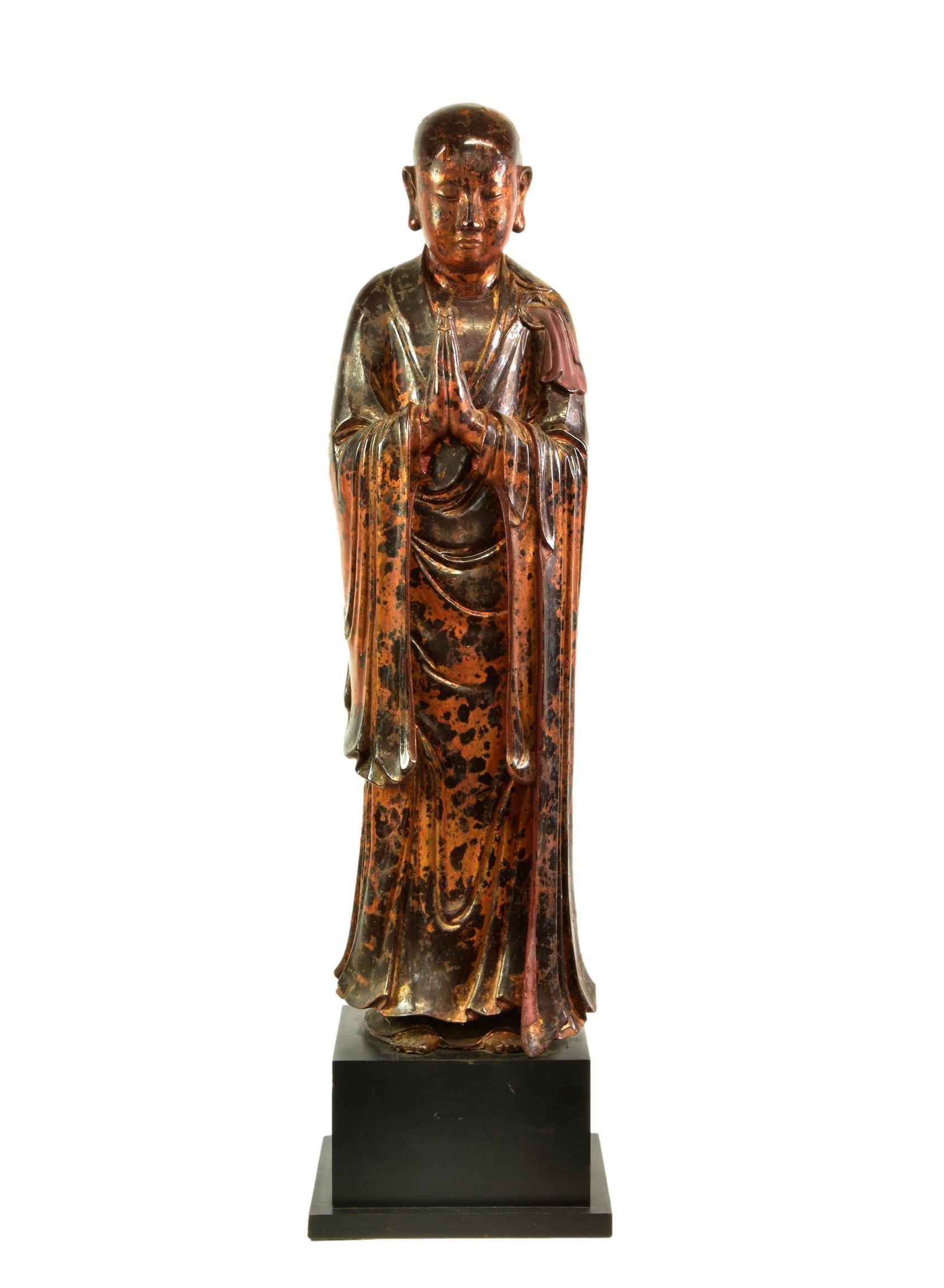 A lacquered and gilt carved wooden figure of a standing monk or Lohan, probably Burmese, Mandalay