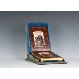 A Victorian blue velvet patented box form photograph album, the shaped box with mirrored roundel