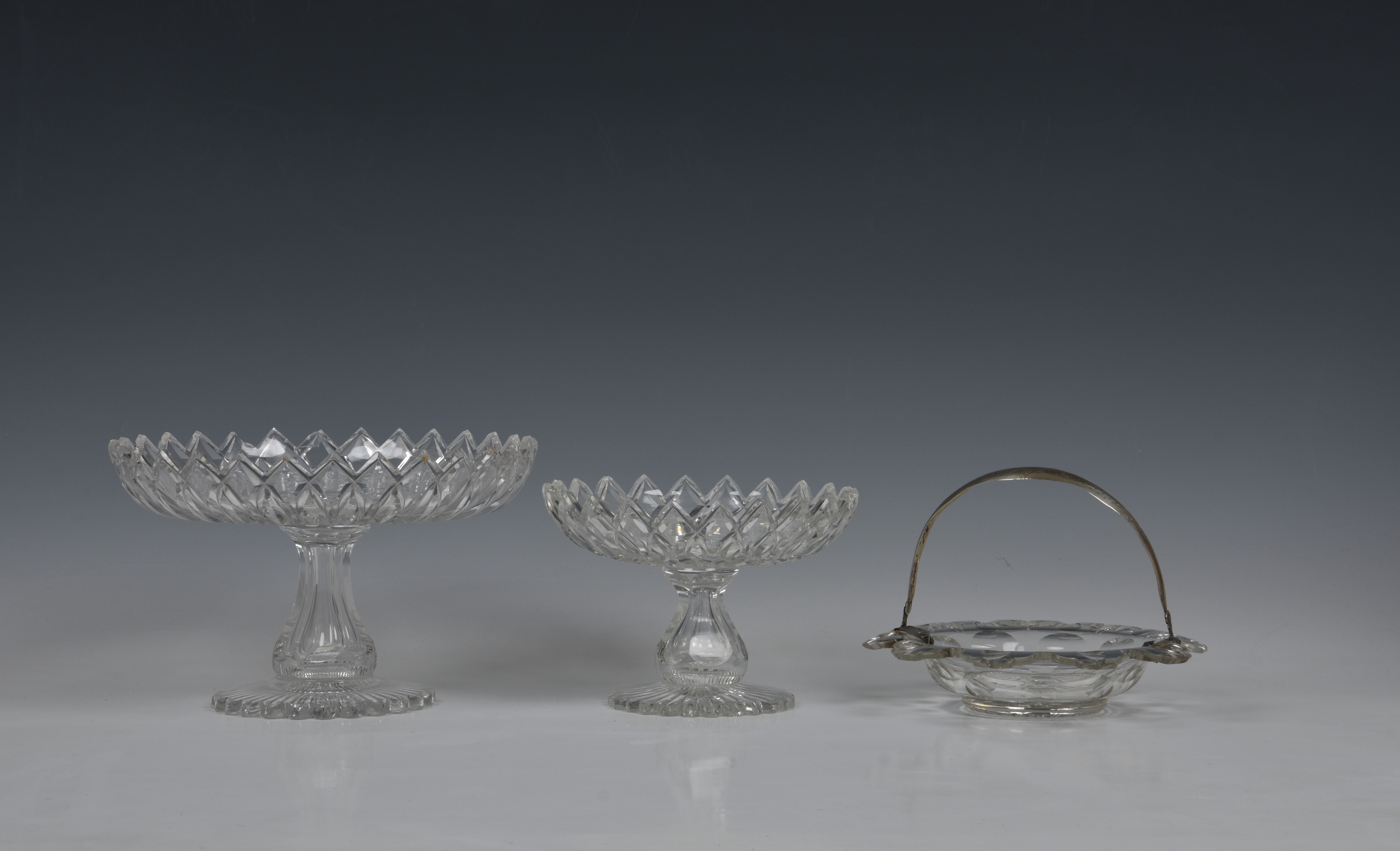 A graduated pair of late Georgian glass tazzas, each shallow bowl cut with interlaced pointed leaves