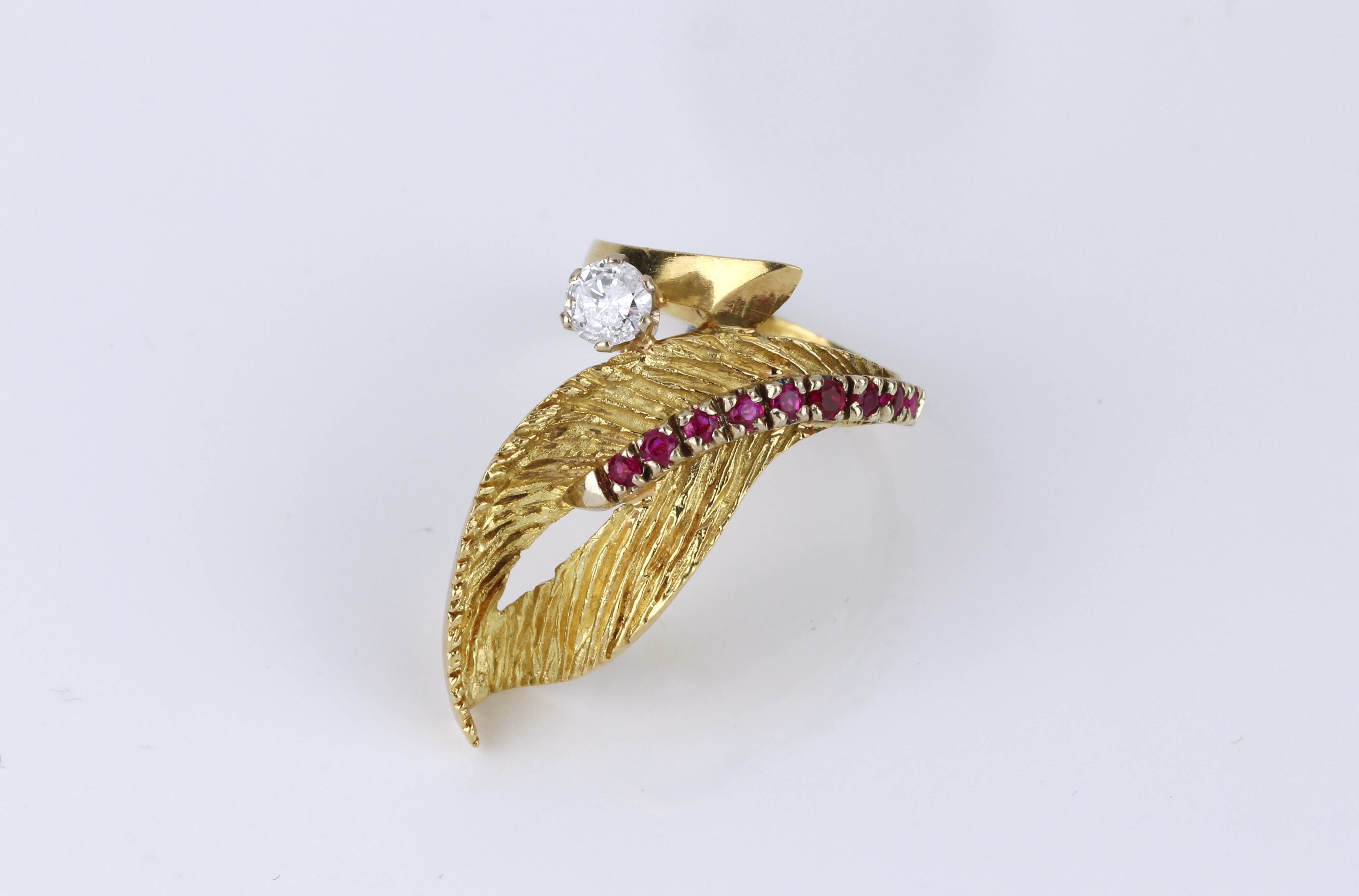 A vintage 18ct yellow gold, ruby and diamond cocktail ring, 1960s-70s, of foliate design, set with a