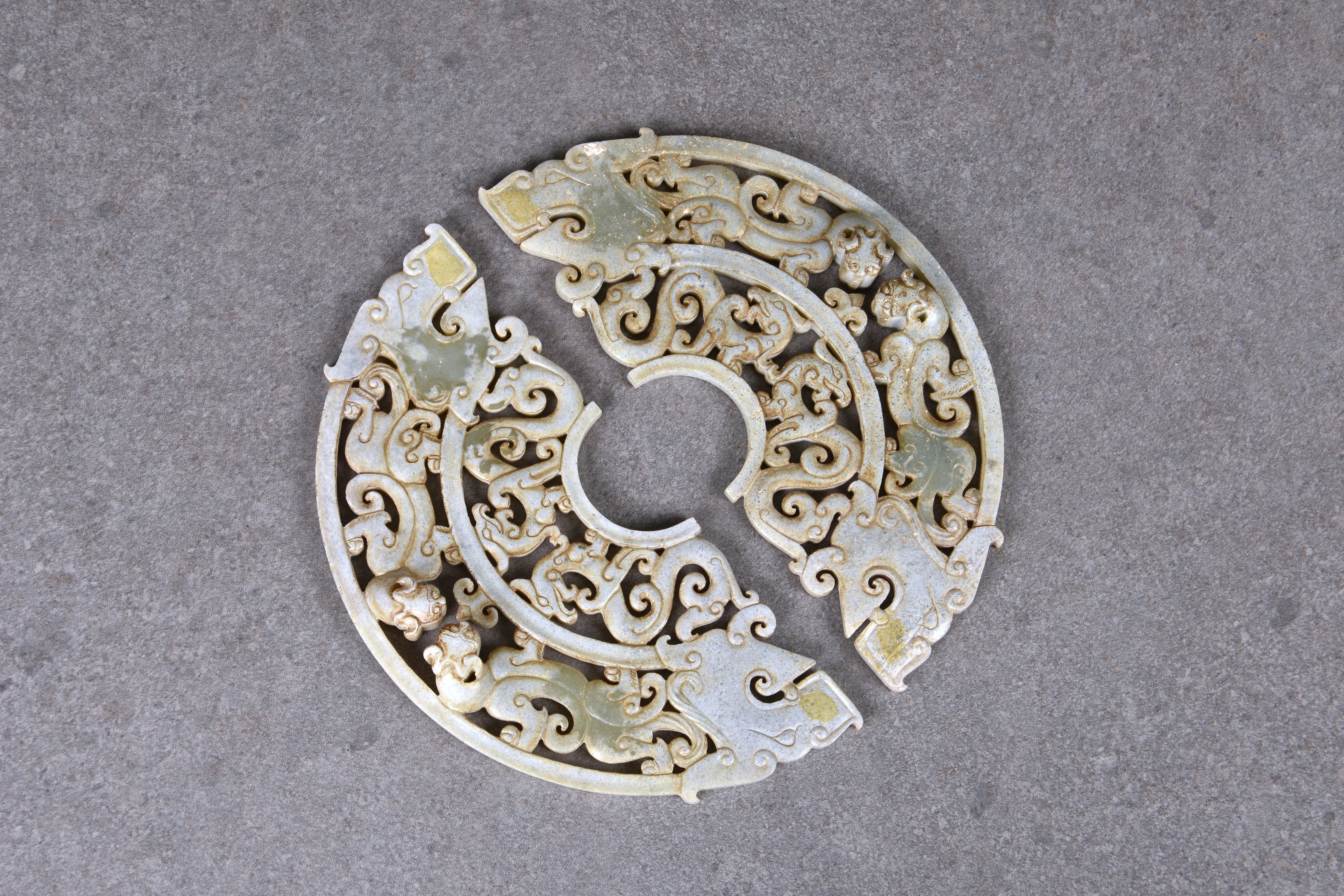 A pair of Chinese celadon jade dragon disc pendants, in the Han Dynasty style, but probably 20th