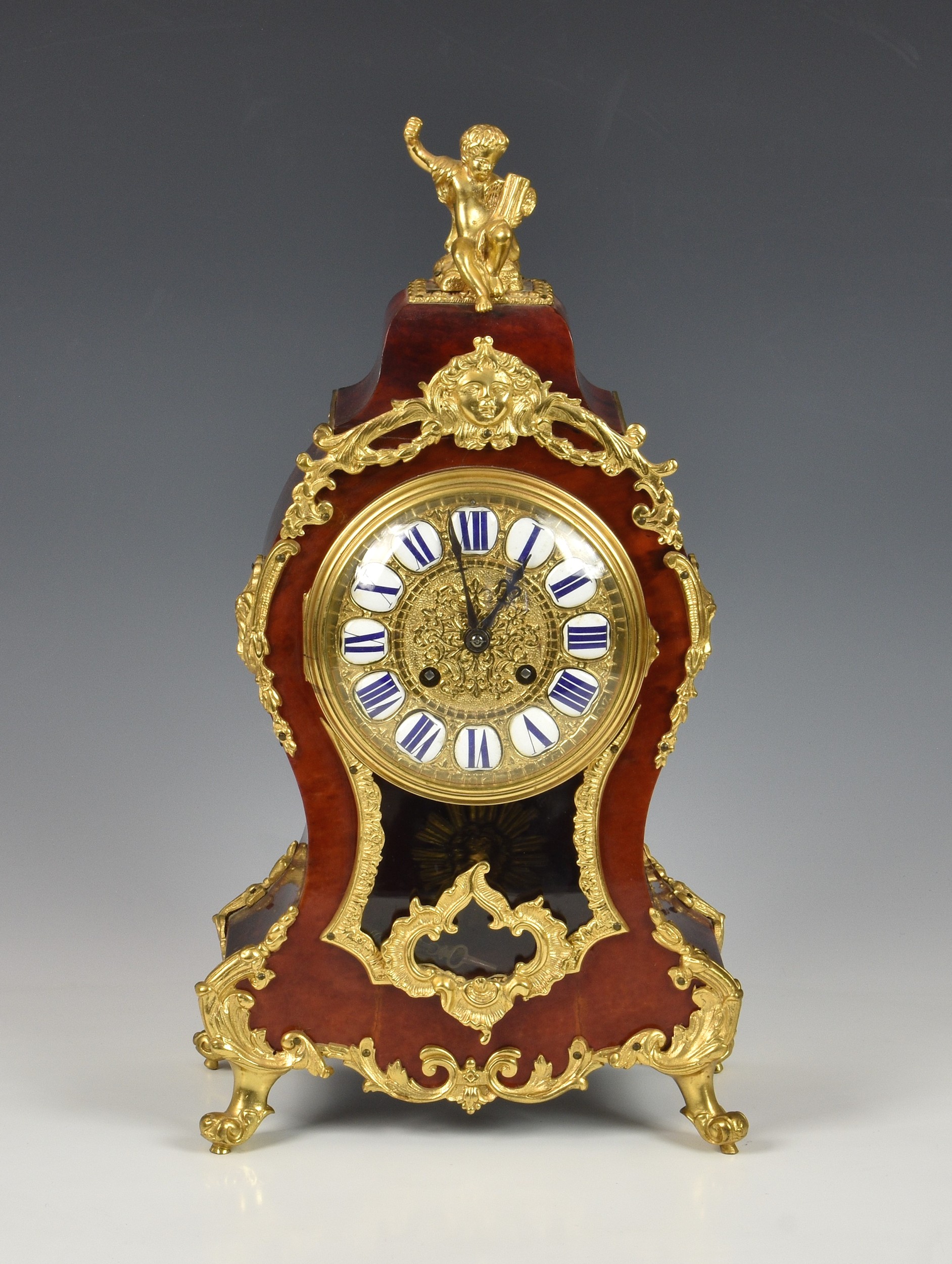 A 19th century tortoiseshell and gilt metal mantel clock, with French style Roman enamel numerals,