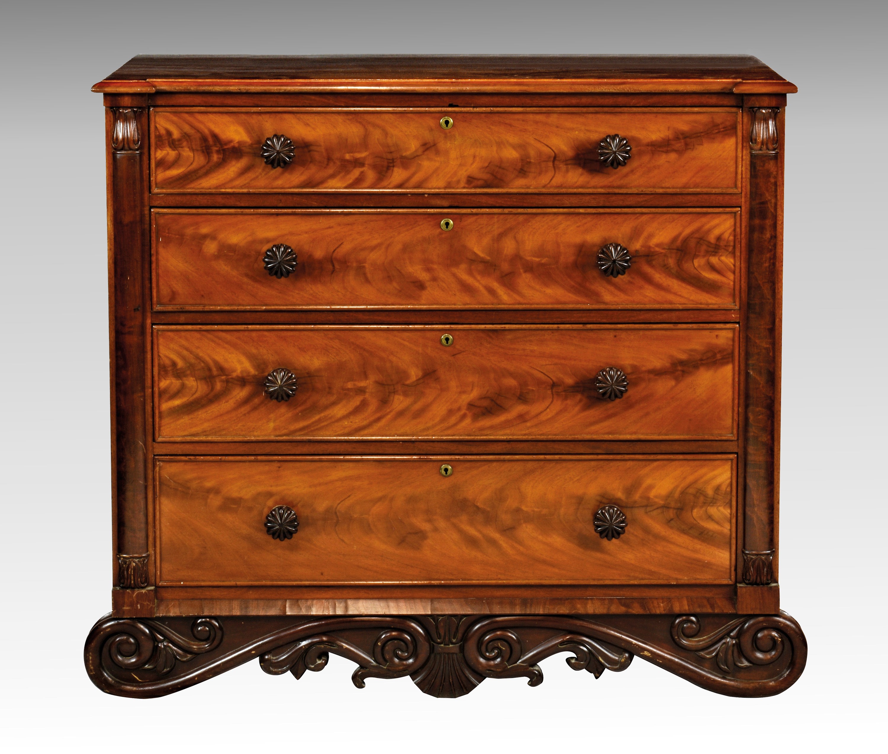 A good William IV mahogany four drawer chest, the moulded top with outset front corners on turned