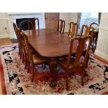 A Queen Anne style walnut extending dining table and chairs, 1920s-30s, the wind-out table with