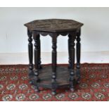 A late Victorian carved oak octagonal centre table, the top carved with palmettes, over a shaped