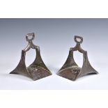 A pair of 19th century Indo-Persian wrought iron stirrups with white and yellow metal damascened