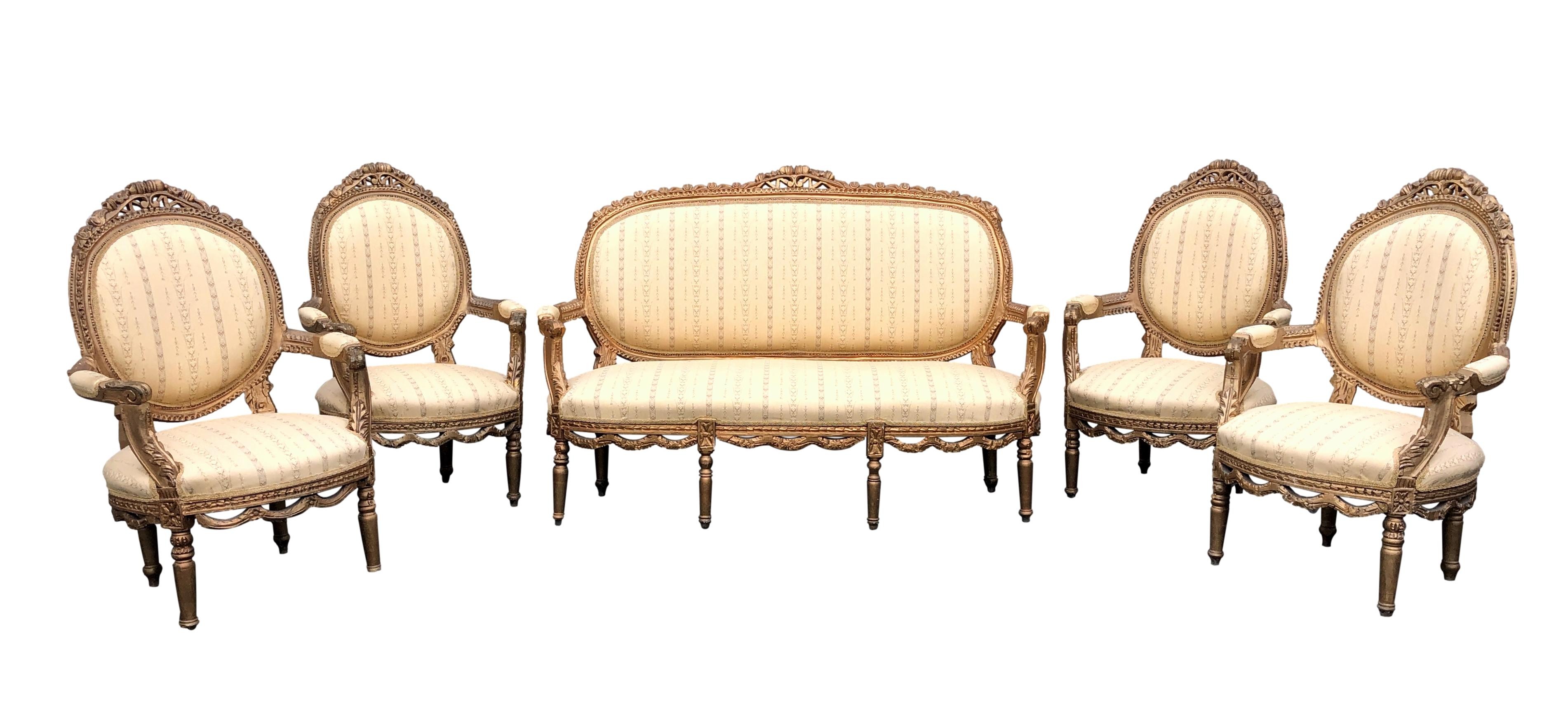 A Louis XVI style gilt painted carved beechwood salon suite, early 20th century, comprising a canape