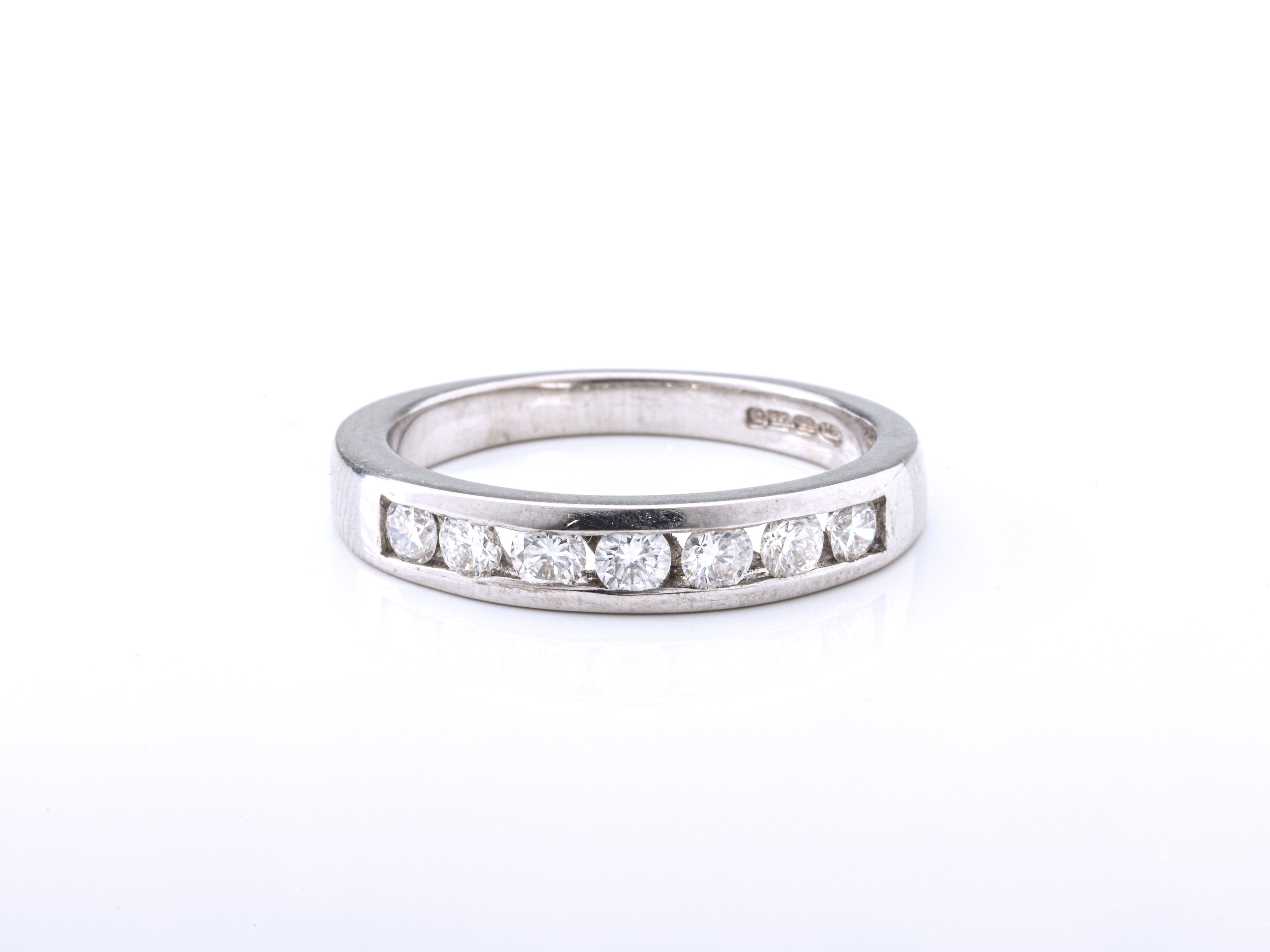 An 18ct white gold and diamond half eternity band, the channel set, brilliant cut diamonds totalling