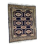 A Turkoman rug, with repeating medallions on a deep blue field with florette and soldat guards and