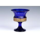 A Moser cobalt blue glass urn with flared rim, acid cut neo classical gilt freeze encircling the