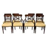 A set of eight Regency mahogany X-back dining chairs, including a pair of carvers, the backs with