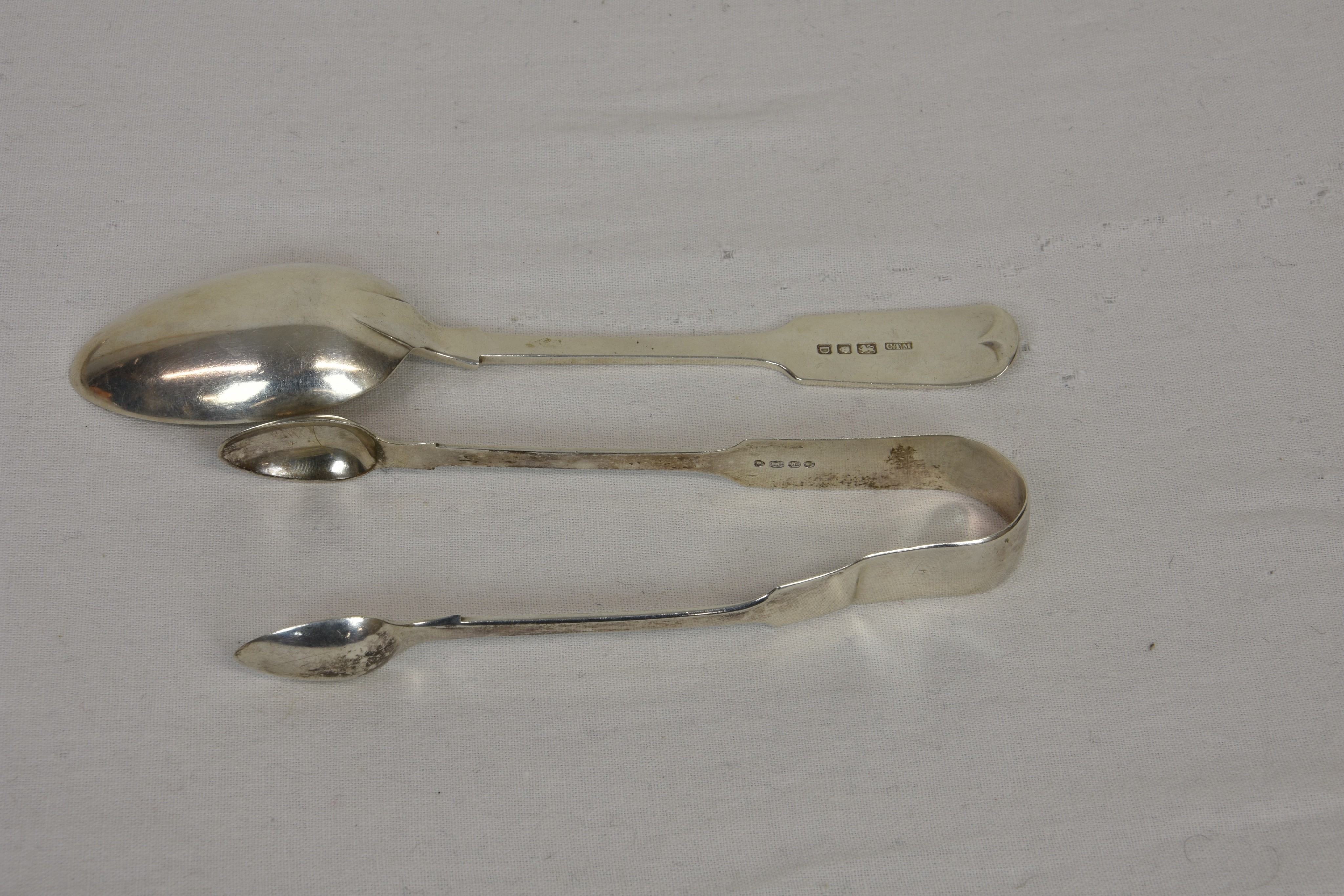 A collection of Channel Islands related silver spoons and sugar tongs, the tongs of typical form, - Image 2 of 2