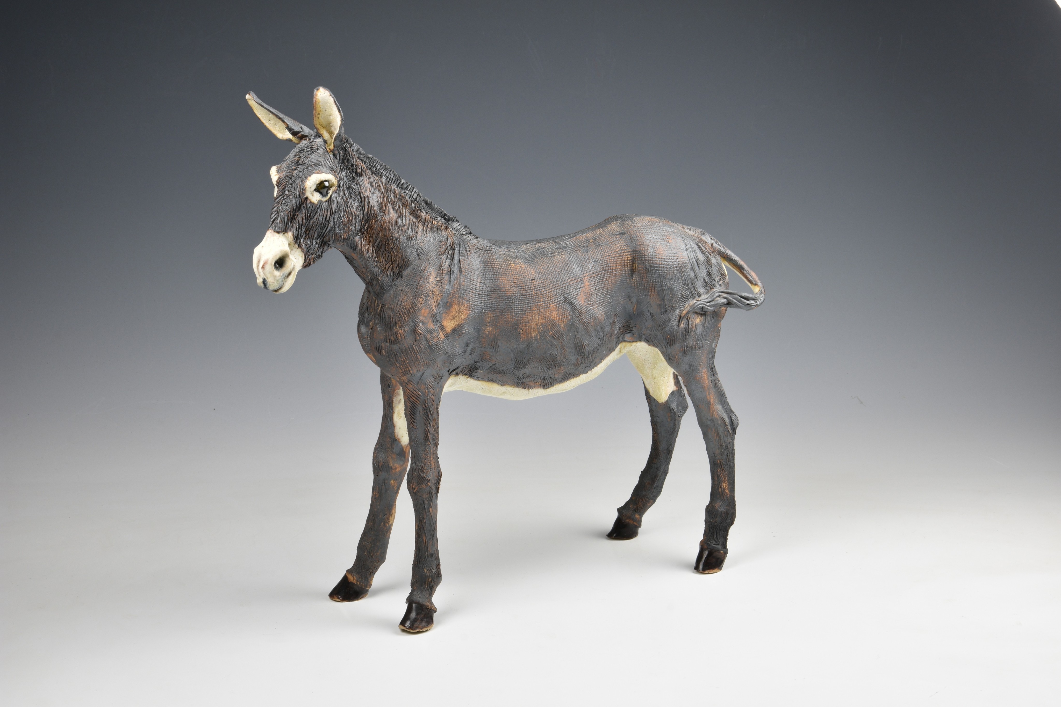 Elaine Peto (British, b.1963), a studio pottery stoneware model of a donkey, impressed potters