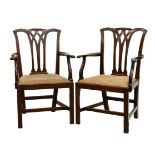 A pair of 18th century mahogany elbow dining chairs, with Chippendale style lattice backs over