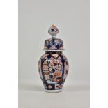 A Japanese Imari baluster vase and cover, in the typical pallete, 13½in. (33.3cm.) high.. * No chips