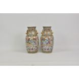 A pair of famille Rose Chinese porcelain baluster vases, 19th century, with gilt foo dog handles,