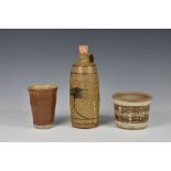 Peter Arnold for Alderney Pottery - three stoneware studio pottery pieces, comprising an oil bottle,