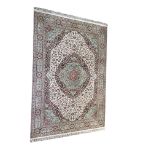 A heavy domestic Wilton wool rug on beige ground by Carmel Carpets of Israel, with floral medallion,